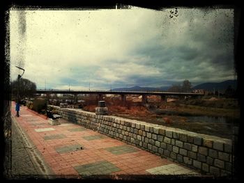 View of bridge against cloudy sky