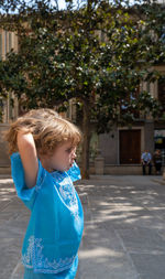 Beautiful blonde girl in arab costumes posing for camera in the streets of granada, spain