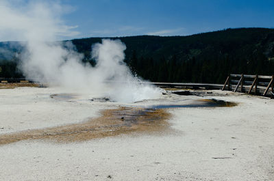 View of hot spring against sky on sunny day