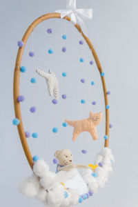 Close-up of multi colored toy hanging over white background