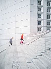 People walking on modern building in city