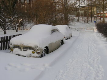 Snow covered car on field