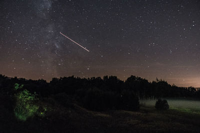 Scenic view of field against sky at night