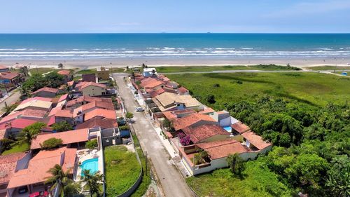 High angle view of buildings by sea against sky