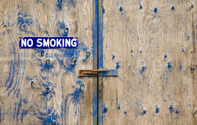 Close-up of text on wooden door