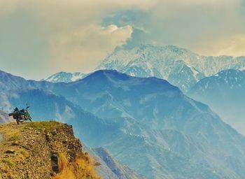 Scenic view of mountains against cloudy sky