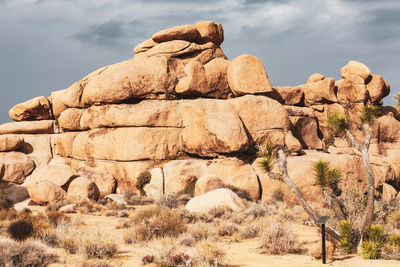 Rock formations on landscape against sky