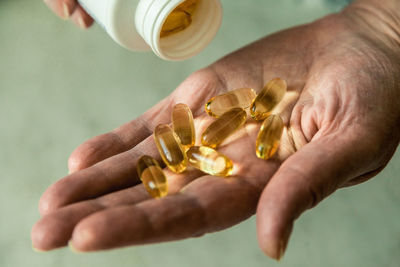 Midsection of men taking capsules