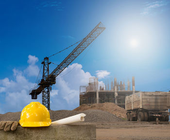 Construction site against blue sky during sunny day