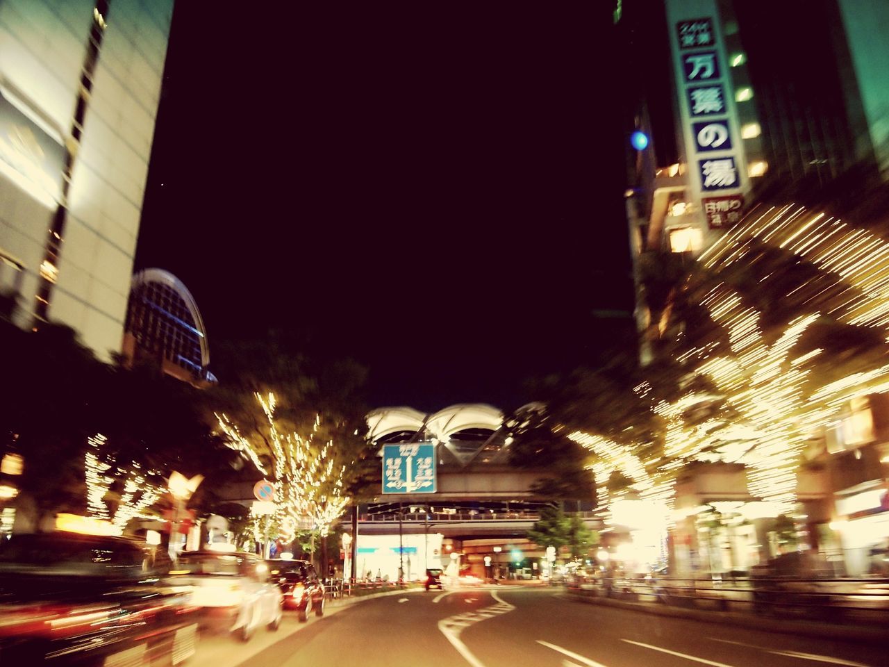 illuminated, night, architecture, building exterior, built structure, city, transportation, street, road, the way forward, city street, car, city life, street light, road marking, lighting equipment, land vehicle, diminishing perspective, building, traffic