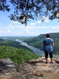 Rear view of woman standing on landscape