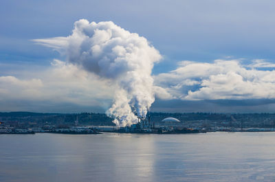 Steam rises from a factory near the port of tacoma.