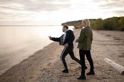 Hipsters throwing stones into water