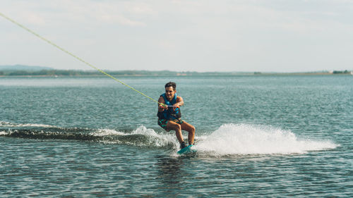 Full length of man doing wakeboard in a lake