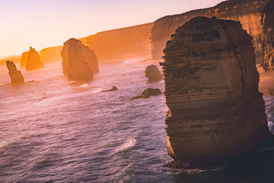 View of rock formation in sea against sky