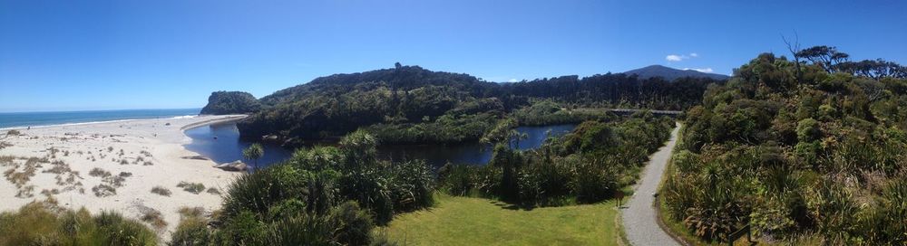 Panoramic shot of sea against clear blue sky