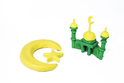 Close-up of yellow toy over white background