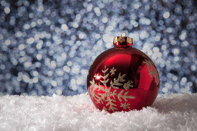 Close-up of red christmas tree in snow