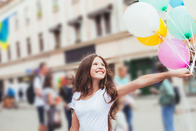 Portrait of a smiling young woman standing outdoors