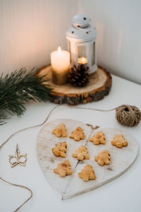 Cozy christmas mood. craft homemade cookies christmas tree shape in wooden tray on table with fir