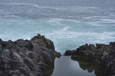 High angle view of rock formations at sea