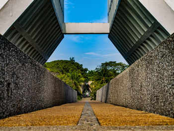 Surface level of footpath by buildings against sky