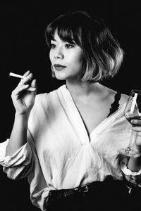 Portrait of woman holding cigarette