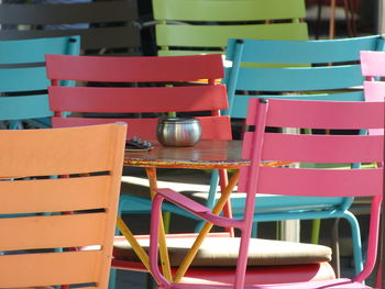 Empty tables and chairs at sidewalk cafe