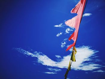 Low angle view of flags hanging against sky