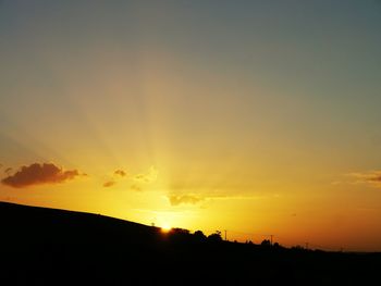 Scenic view of silhouette yellow against sky during sunset