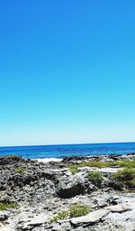 Scenic view of sea against clear blue sky