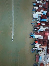 High angle view of buildings by lake in city