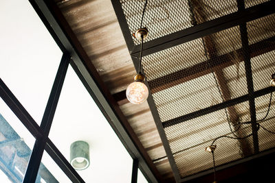 Low angle view of illuminated light hanging from ceiling