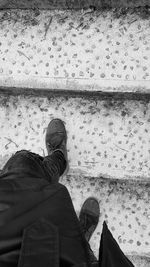 Low section of man standing on ground