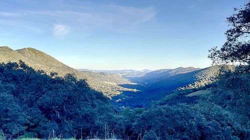 Scenic view of mountains against blue sky