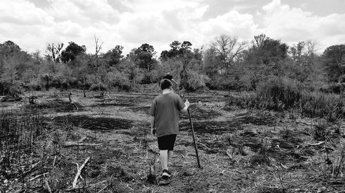 Rear view of man hiking in forest