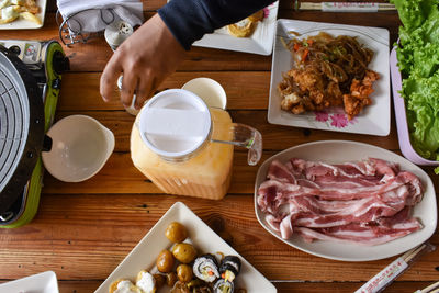 High angle view of man preparing food on table