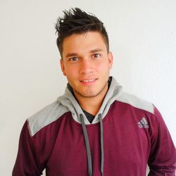 Portrait of smiling young man against white background