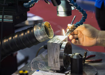 Midsection of man working at machine