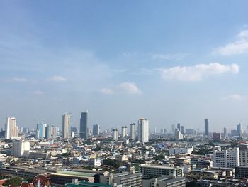 Modern buildings in city against sky