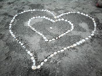 High angle view of heart shape on sand