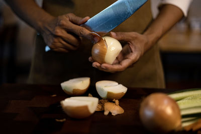 Cropped hands of man preparing food