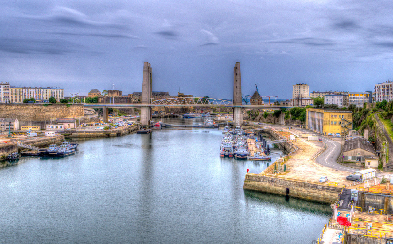 architecture, built structure, water, cityscape, city, building exterior, transportation, river, sky, cloud, travel destinations, building, nature, waterway, nautical vessel, bridge, landscape, travel, skyline, reflection, industry, no people, harbor, environment, high angle view, mode of transportation, urban skyline, landmark, outdoors, dusk, ship, tourism, street, town, urban area, night, tower, waterfront, history, city life, port, the past, business finance and industry