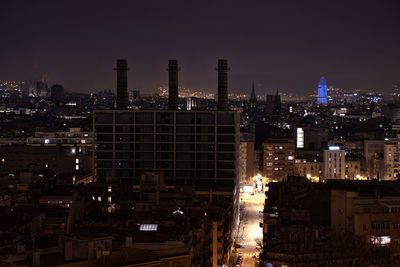 Illuminated cityscape against sky at night