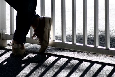 Low section of man walking on railroad track