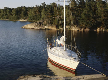 Boat sailing on lake against sky