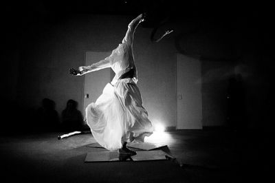 Midsection of woman dancing at music concert