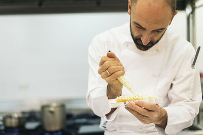 Chef preparing food in commercial kitchen