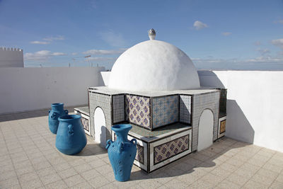 Close-up of dome by jugs at building terrace