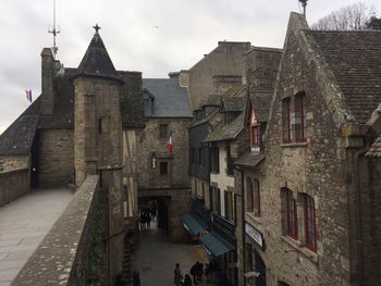 Street amidst buildings in town against sky